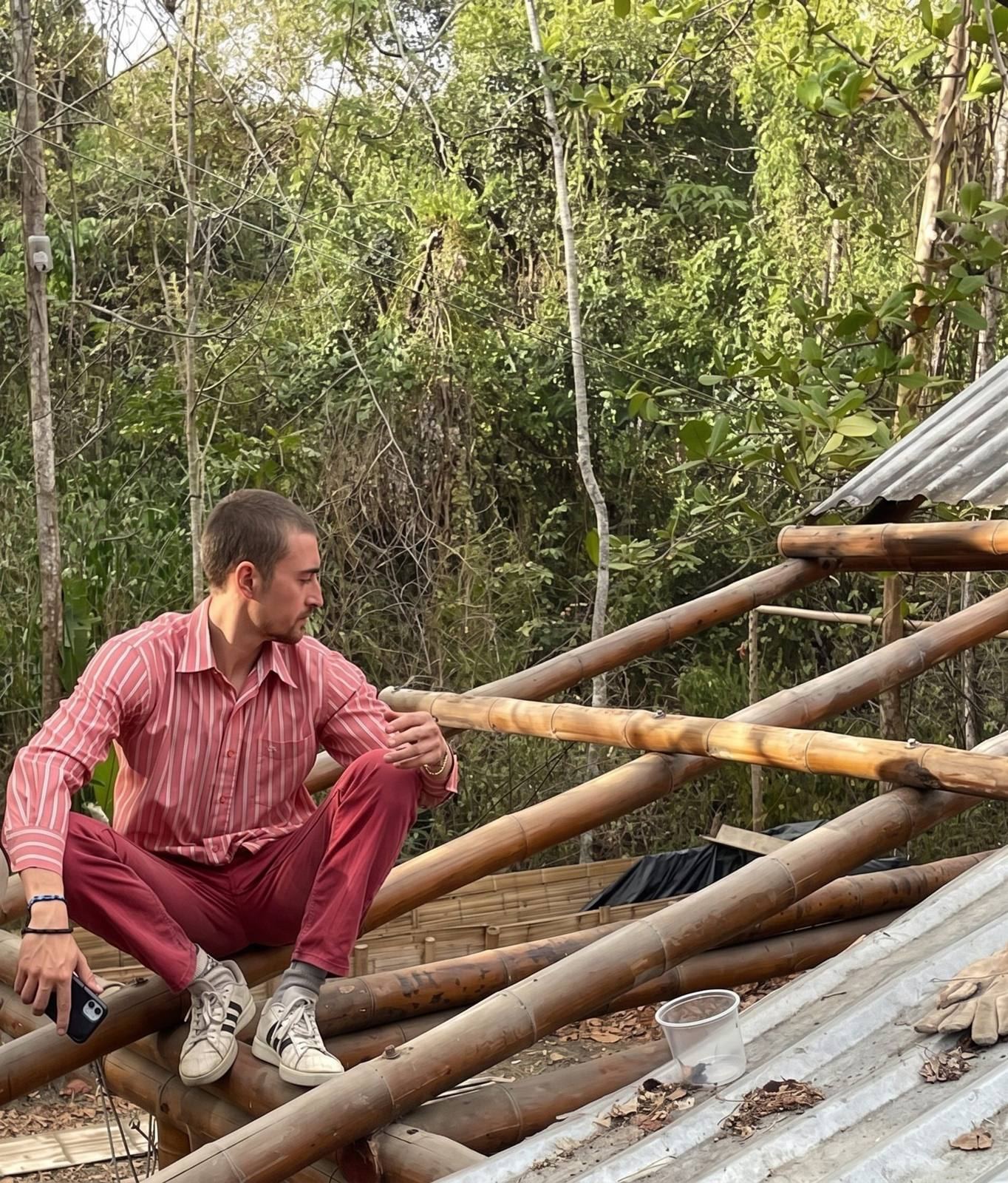 Nicolás Carrasco González sentado sobre una estructura de guadua en obra